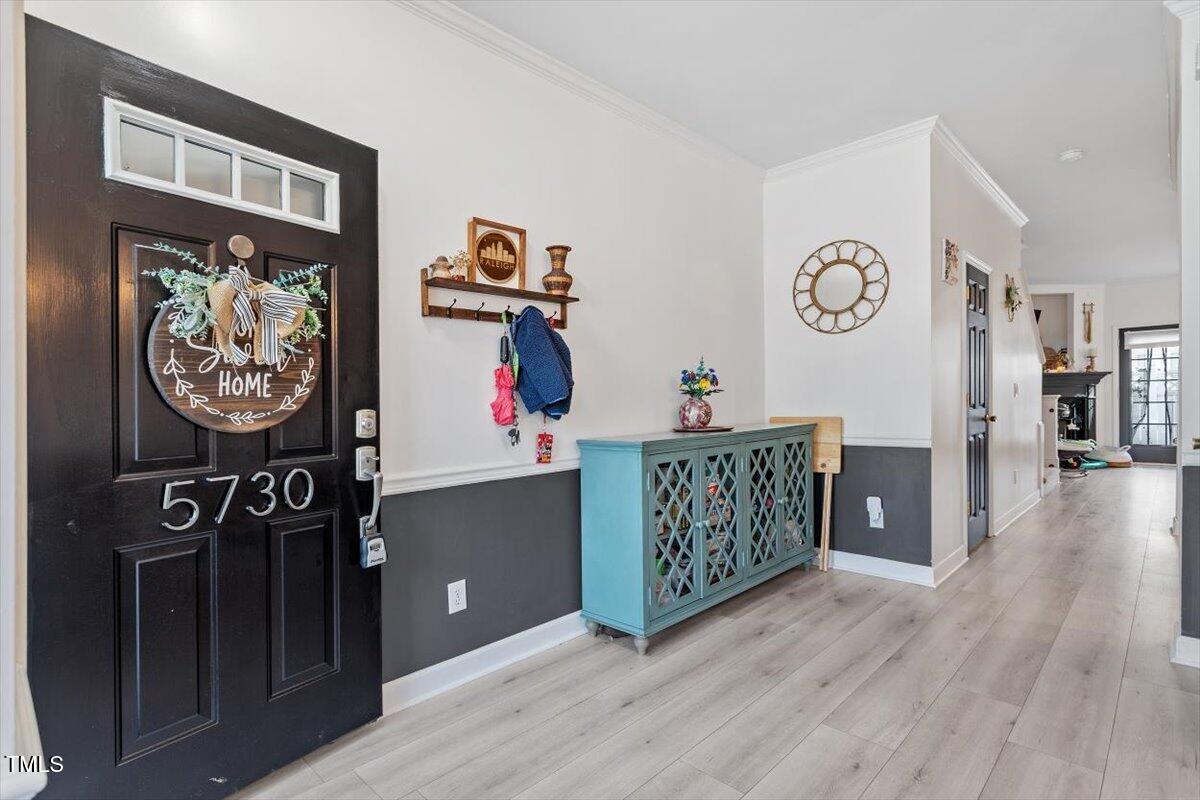 5730 Clearbay Lane Raleigh, NC 27612 - Photo 6 of 32 a view of an entryway with wooden floor