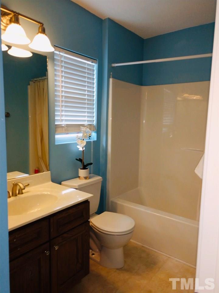 3101 Marcony Way Raleigh, NC 27610 - Photo 15 of 16 a bathroom with a sink a toilet and shower