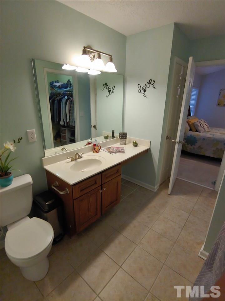3101 Marcony Way Raleigh, NC 27610 - Photo 16 of 16 a bathroom with a sink a toilet and mirror