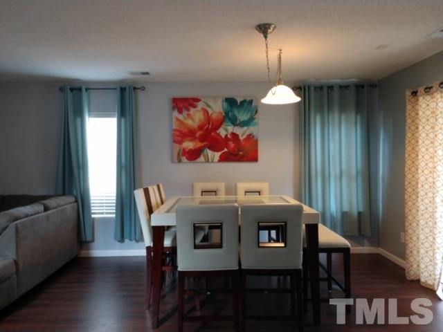 3101 Marcony Way Raleigh, NC 27610 - Photo 7 of 16 a view of a dining room with furniture wooden floor and a chandelier