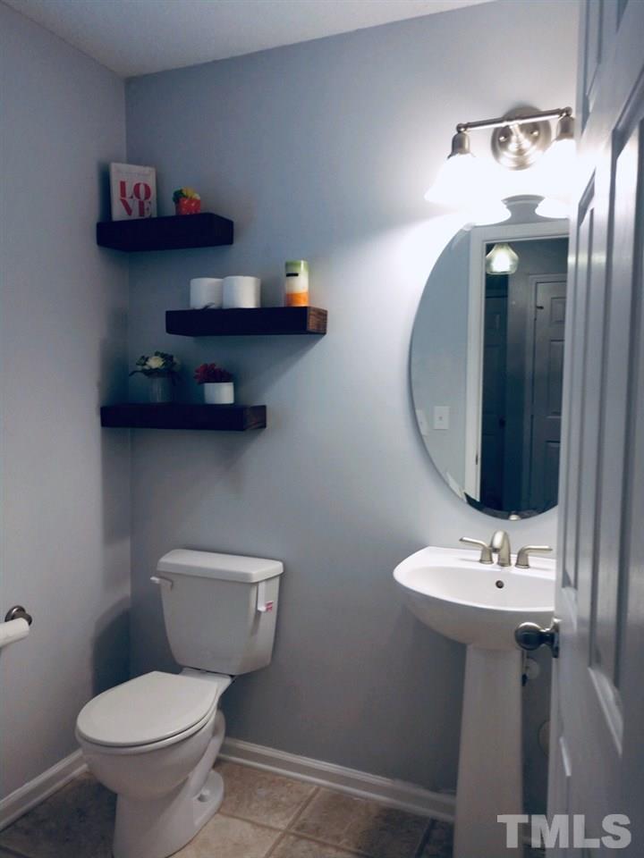 3101 Marcony Way Raleigh, NC 27610 - Photo 9 of 16 a bathroom with a toilet sink and mirror