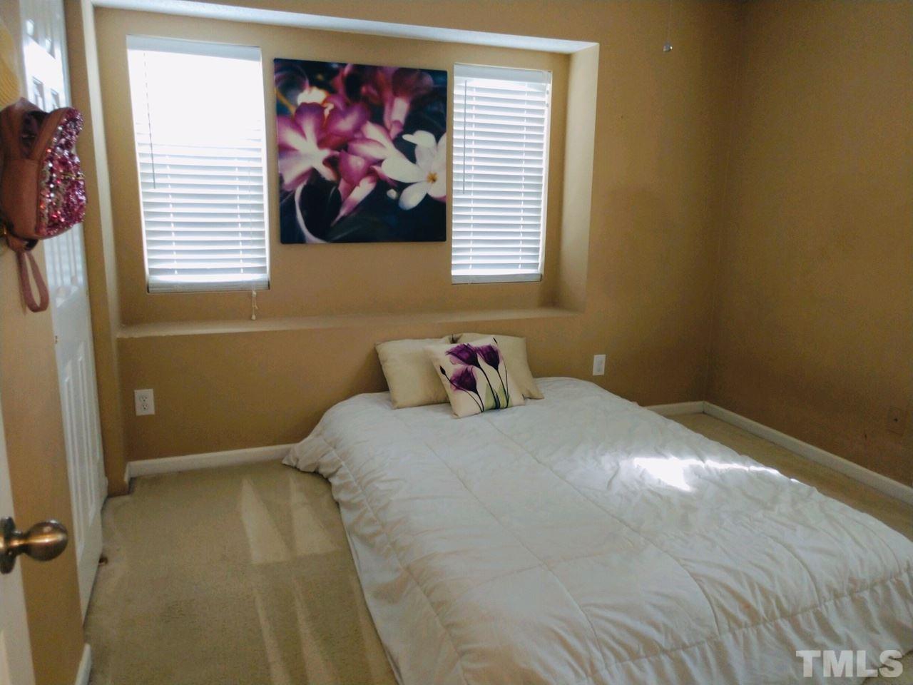 3101 Marcony Way Raleigh, NC 27610 - Photo 10 of 16 a bedroom with a bed and a window