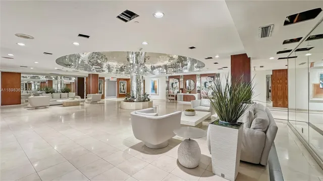 a living room with lots of furniture and a chandelier