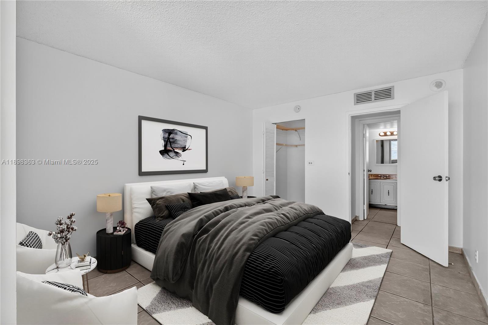 2655 Collins Avenue, Unit 1502 Miami Beach, FL 33140 - Photo 5 of 11 a bedroom with a bed and a couch