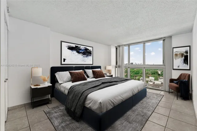 a spacious bedroom with a bed and glass windows