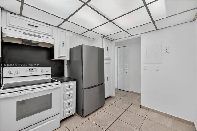 a kitchen with stainless steel appliances a refrigerator and a stove top oven