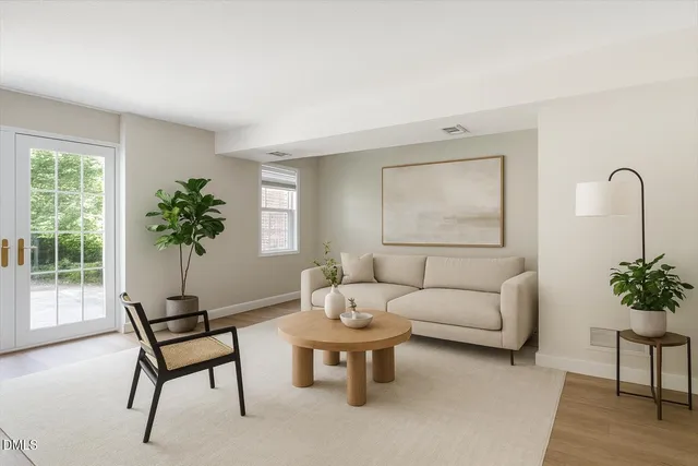 a living room with furniture potted plant and a window