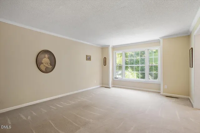 a view of room with window and a fan
