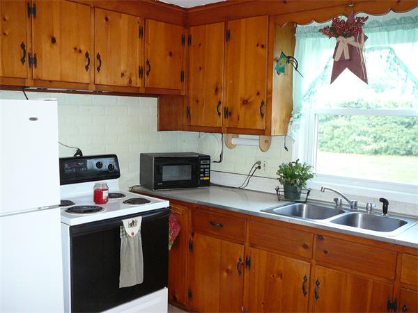 343 Evergreen Road Springfield, MA 01119 - Photo 4 of 29 a kitchen with stainless steel appliances granite countertop a sink stove and cabinets