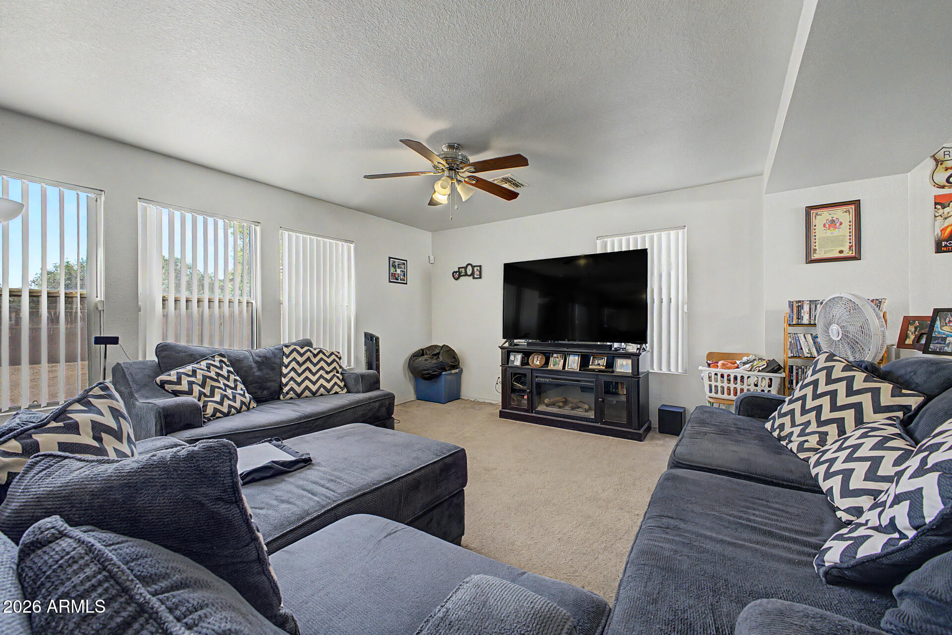 2607 West Bloch Road Phoenix, AZ 85041 - Photo 8 of 34 a living room with furniture and a flat screen tv