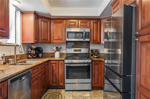 a kitchen with stainless steel appliances granite countertop a stove and a sink