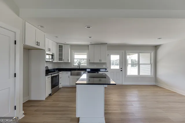 a kitchen with granite countertop a stove and a refrigerator