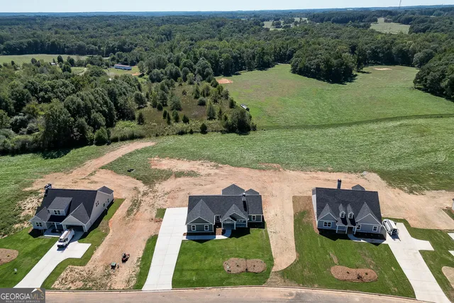 an aerial view of a house with yard swimming pool and outdoor seating