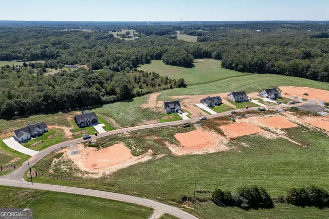 an aerial view of a house with yard