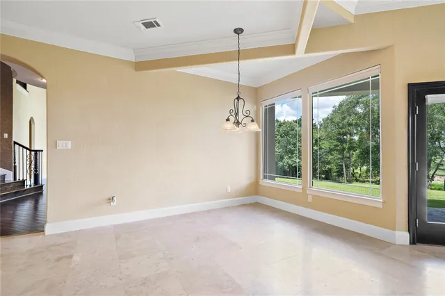 a spacious bedroom with a bed and a large window