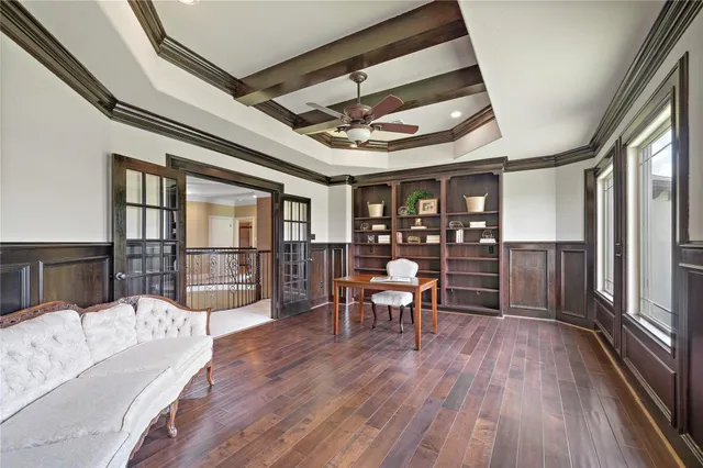 a view of a livingroom with a ceiling fan and window