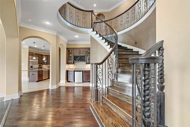 a view of entryway and hall with wooden floor