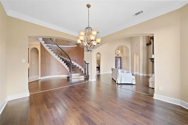 a large kitchen with kitchen island a large counter top stainless steel appliances and cabinets