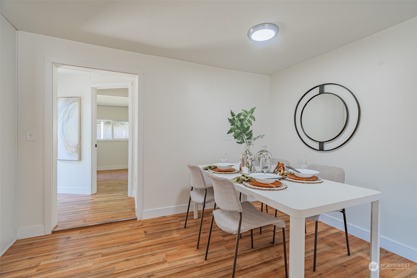 2426 Southwest 328th Street Federal Way, WA 98023 - Photo 16 of 39 a dining room with wooden floor a glass table and chairs