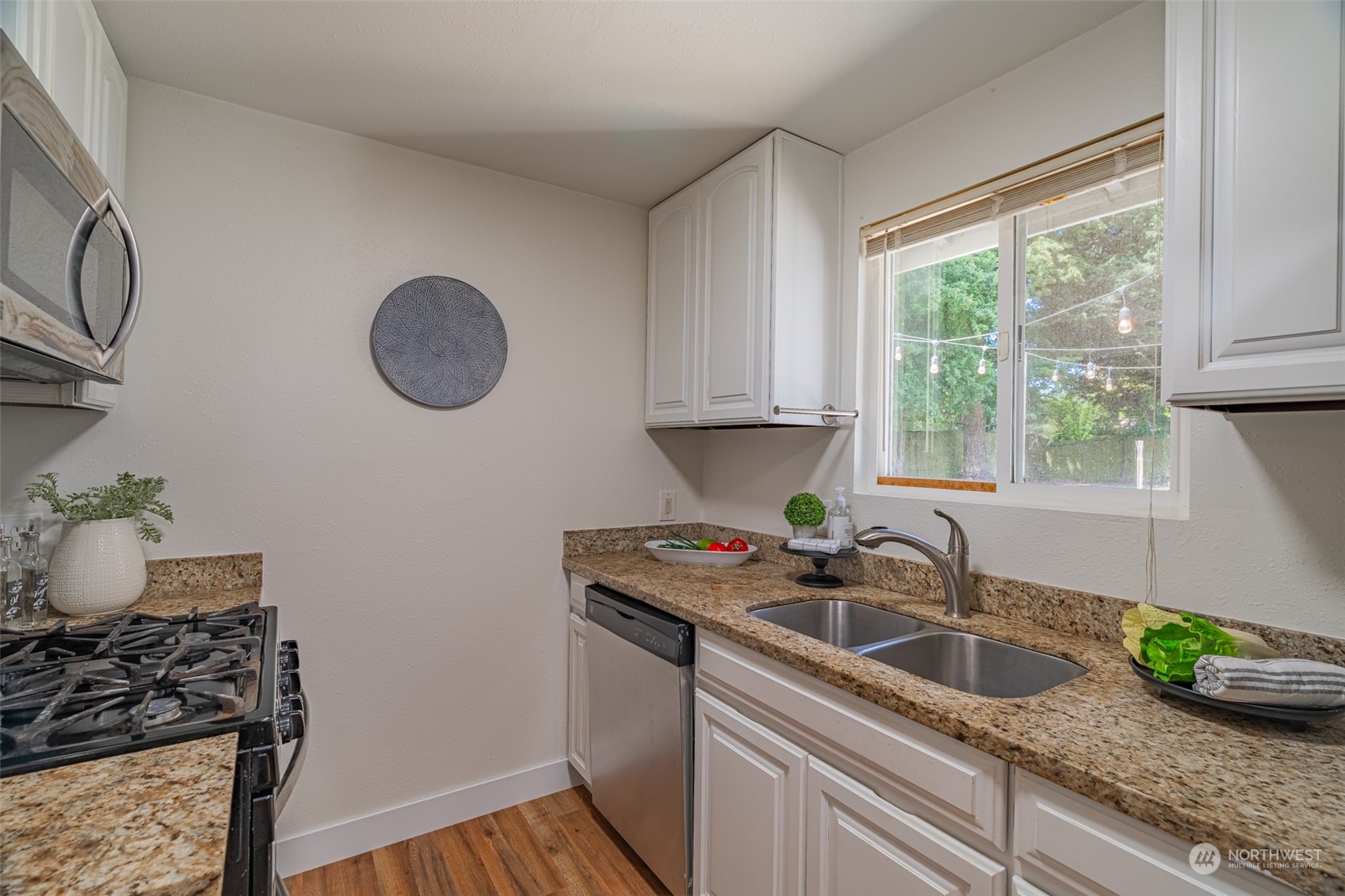 2426 Southwest 328th Street Federal Way, WA 98023 - Photo 21 of 39 a kitchen with granite countertop a sink a stove and cabinets