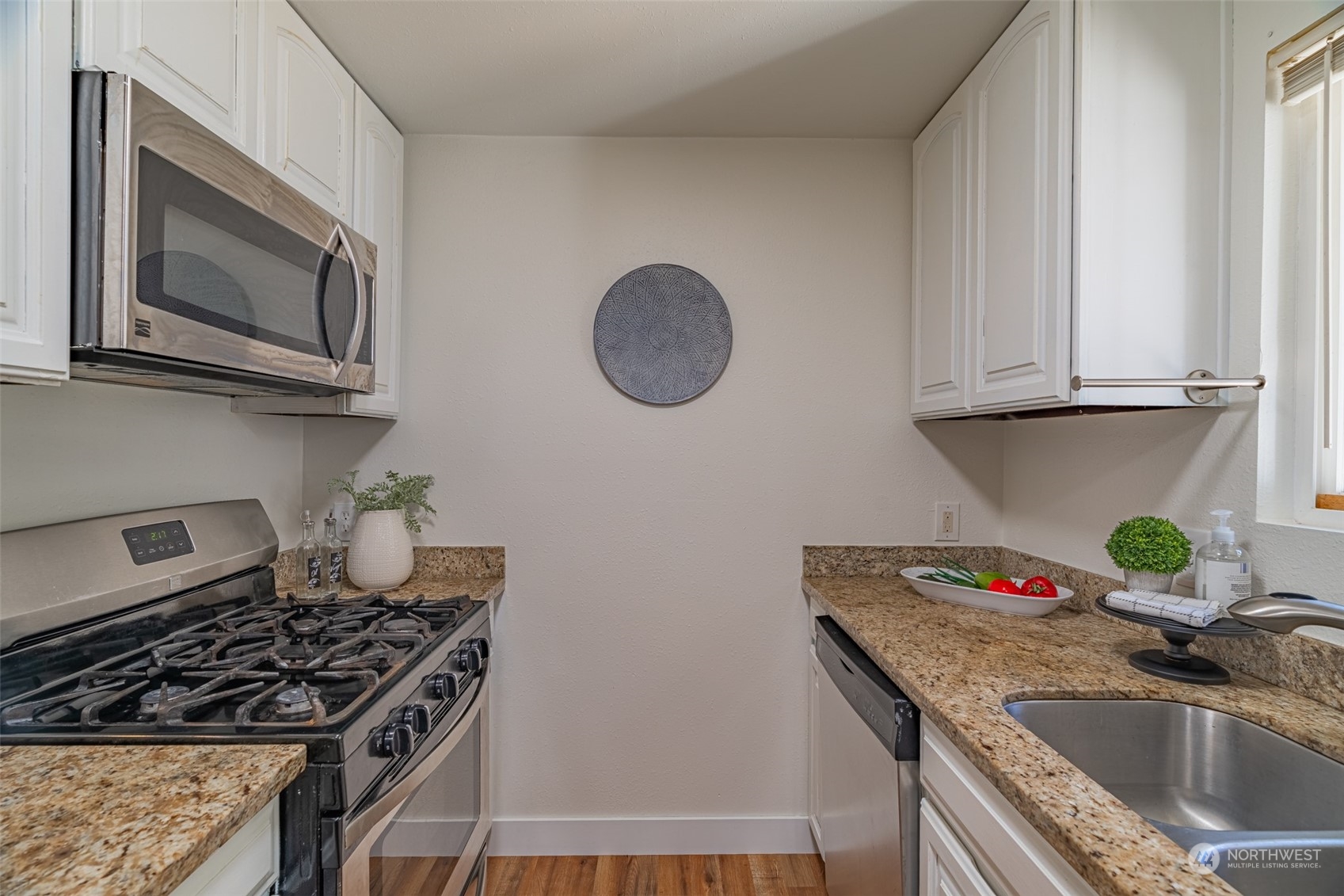 2426 Southwest 328th Street Federal Way, WA 98023 - Photo 22 of 39 a kitchen with granite countertop a sink a stove and cabinets