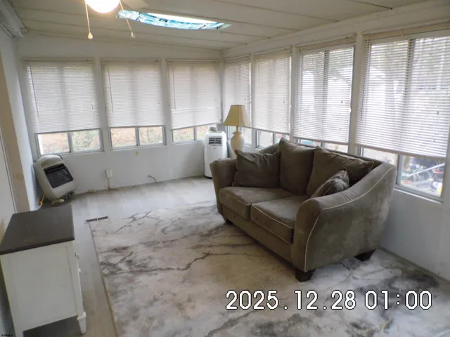 a living room with furniture and a ceiling fan