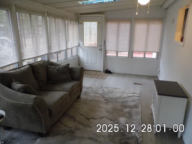 a view of a livingroom with furniture and staircase