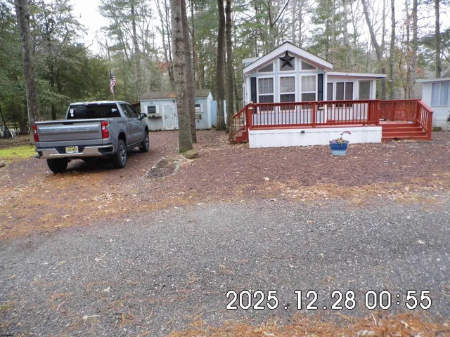 a view of house with car parked in front of it