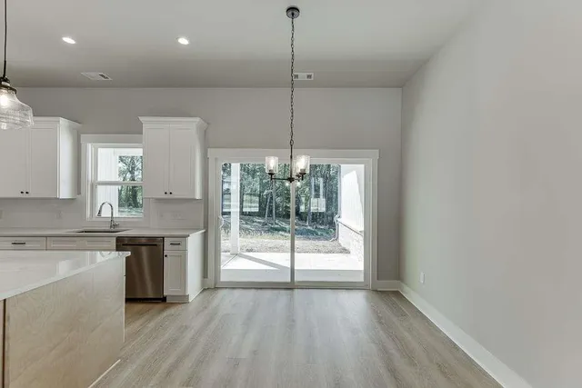 a open kitchen with kitchen island a stove a counter top space and wooden floor