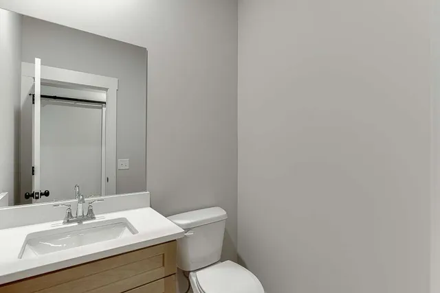 a white toilet sitting next to a bathroom sink