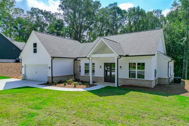 a front view of a house with garden