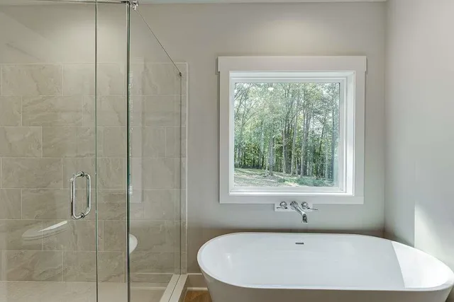 a bathroom with a tub and shower