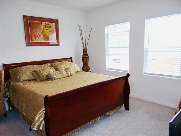 a bedroom with a bed and window