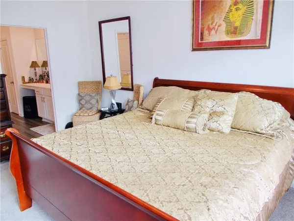 a large bed sitting in a bedroom with a large window