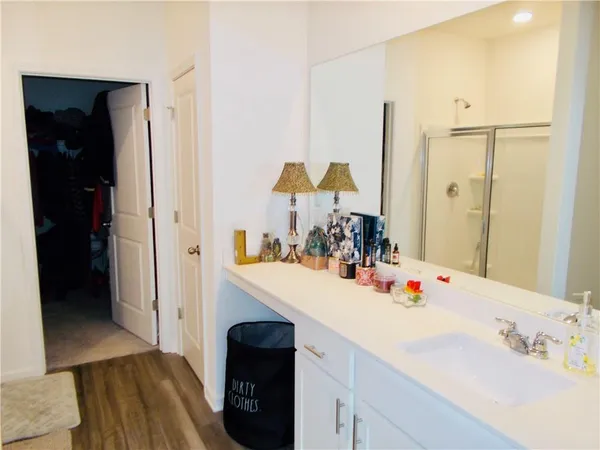 a bathroom with a sink vanity and a mirror
