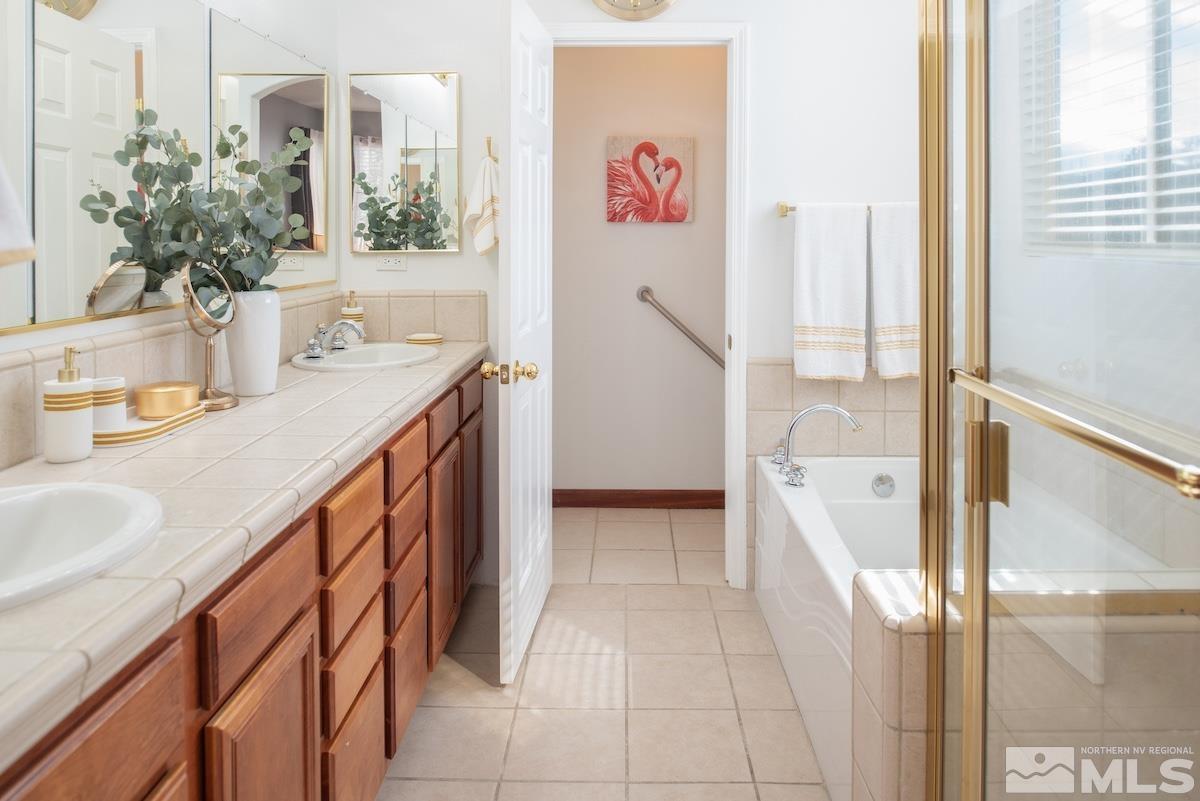 10417 Chadwell Drive Reno, NV 89521 - Photo 15 of 40 a hallway with a sink and a refrigerator