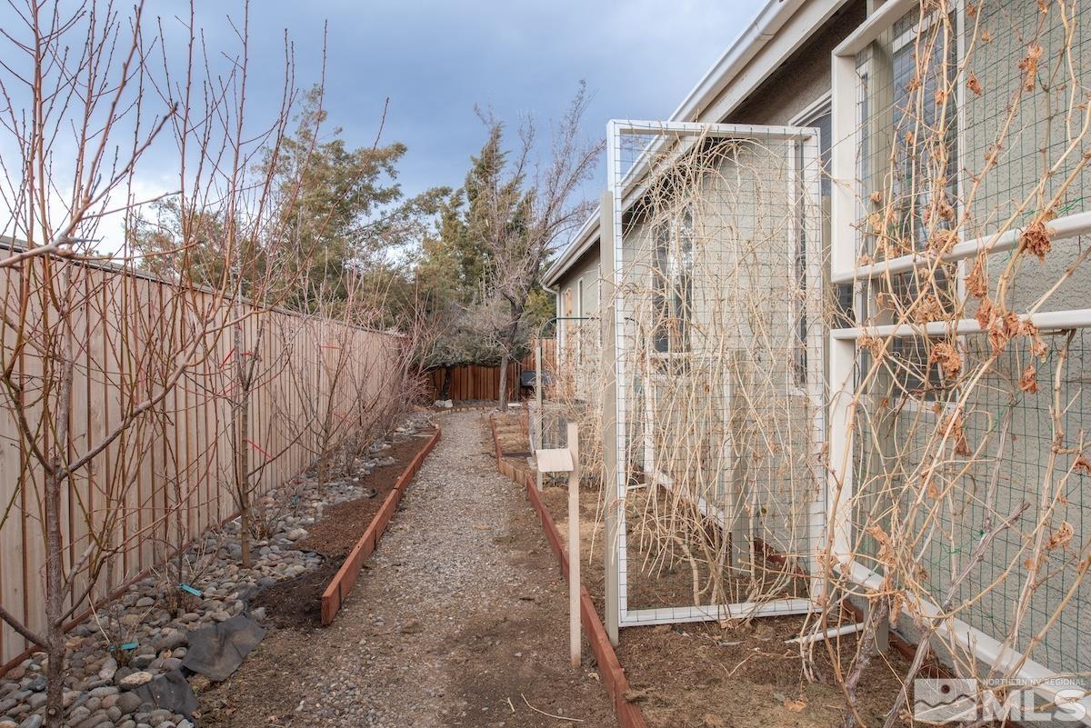 10417 Chadwell Drive Reno, NV 89521 - Photo 29 of 40 a view of a pathway of a building with wooden fence