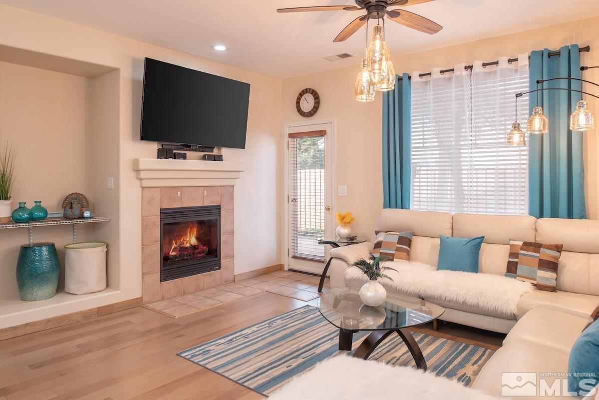10417 Chadwell Drive Reno, NV 89521 - Photo 3 of 40 a living room with furniture a flat screen tv and a fireplace