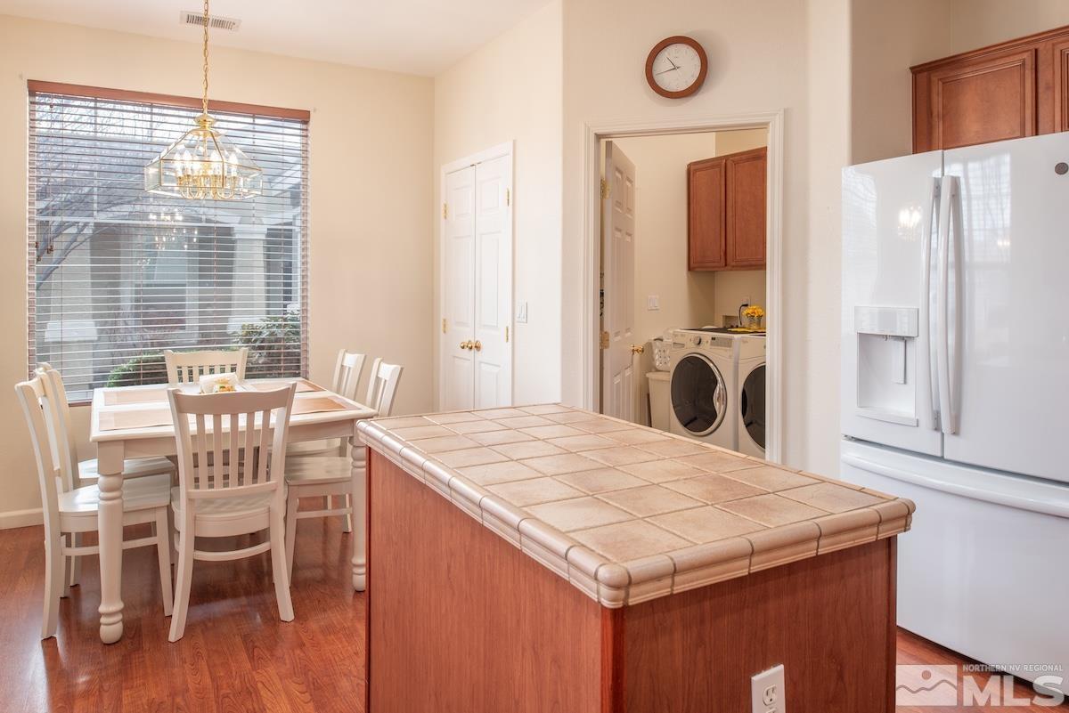 10417 Chadwell Drive Reno, NV 89521 - Photo 7 of 40 a kitchen with a table chairs and a refrigerator