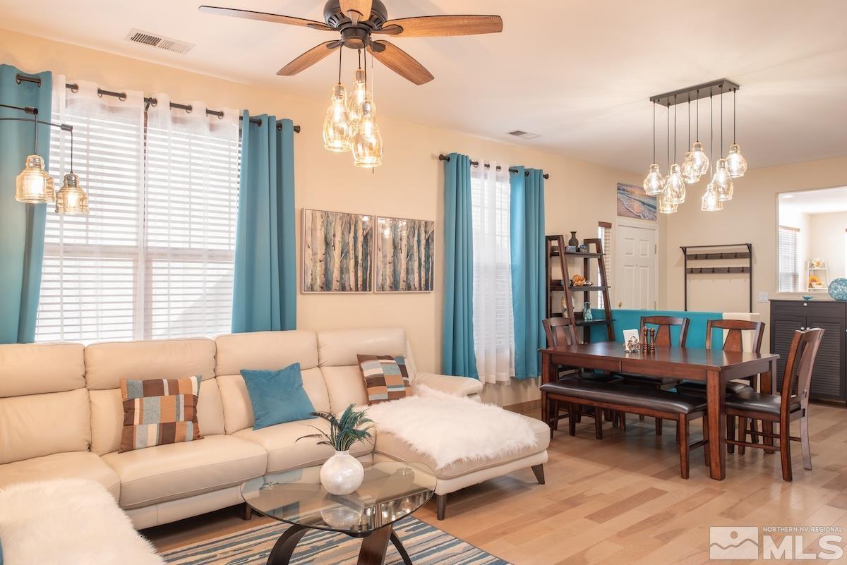 10417 Chadwell Drive Reno, NV 89521 - Photo 9 of 40 a living room with furniture a table and a chandelier