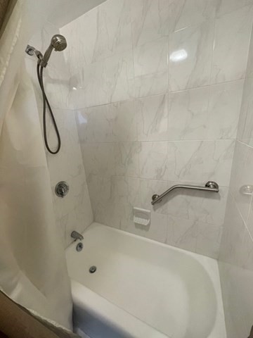 1600 Beacon Street, Unit 1012 Brookline, MA 02446 - Photo 17 of 27 a bathroom with a bath tub with a shower