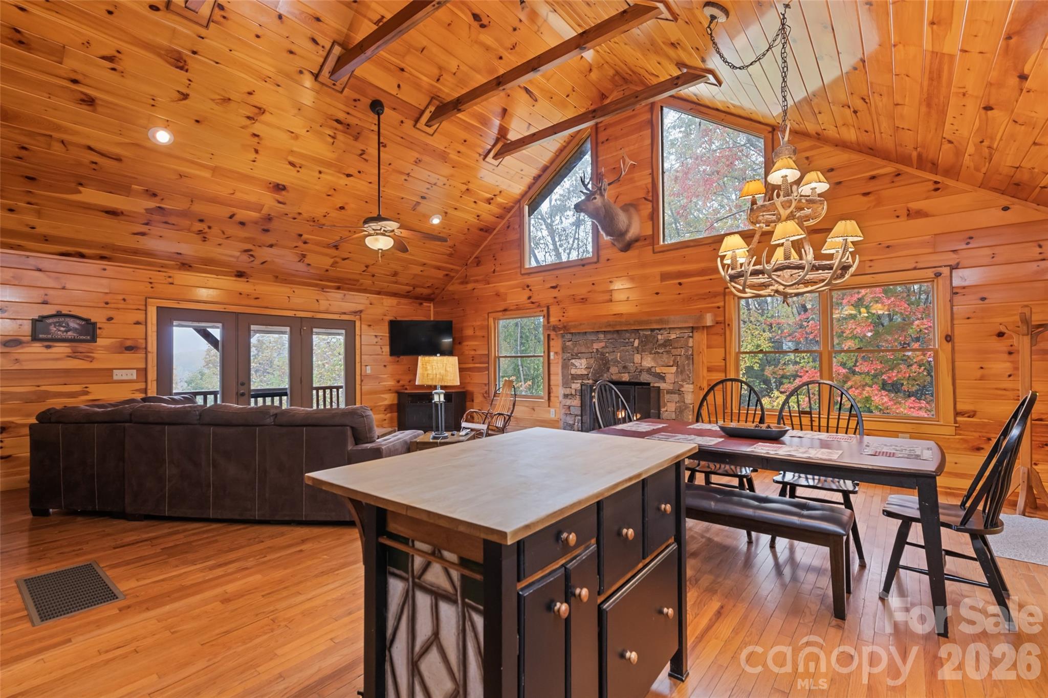 235 Soaring Eagle Road Bryson City, NC 28713 - Photo 15 of 42 a view of a patio with table and chairs with wooden floor