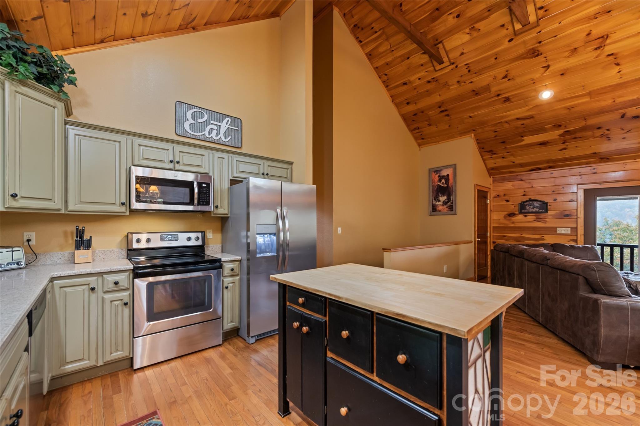 235 Soaring Eagle Road Bryson City, NC 28713 - Photo 16 of 42 a kitchen with stainless steel appliances and wooden cabinets
