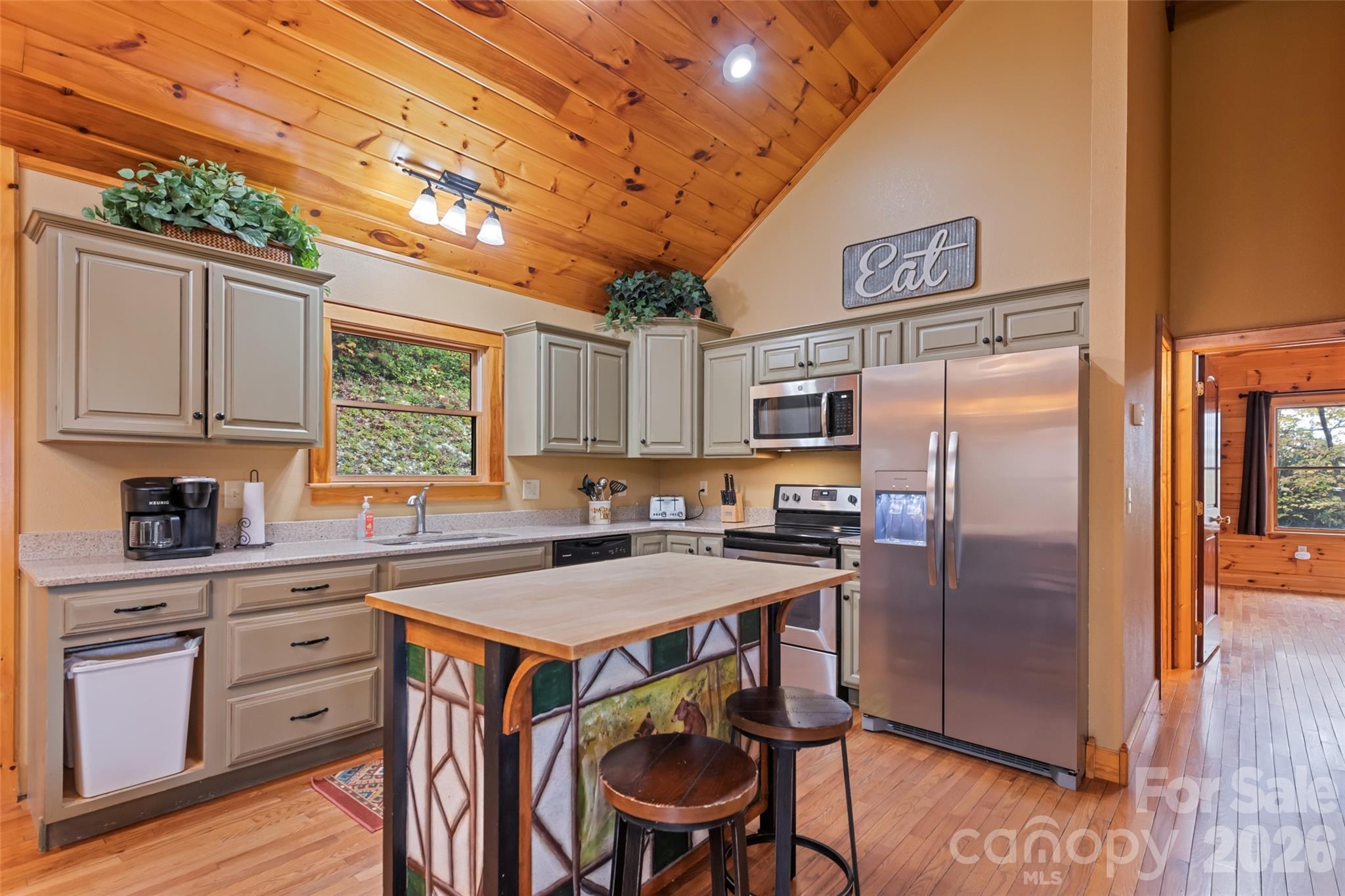 235 Soaring Eagle Road Bryson City, NC 28713 - Photo 16 of 43 a kitchen with stainless steel appliances granite countertop a refrigerator a sink a stove and white cabinets