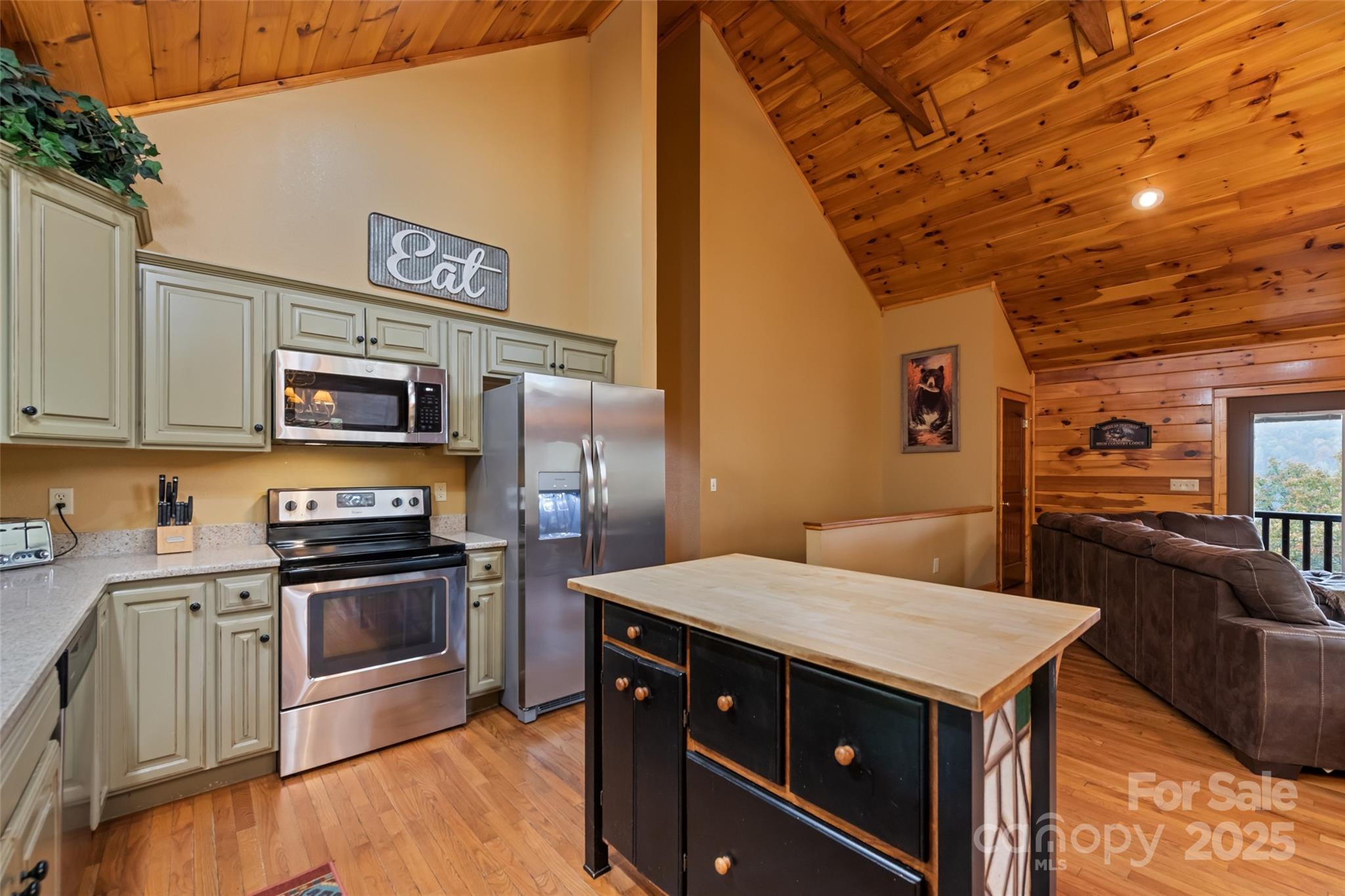 235 Soaring Eagle Road Bryson City, NC 28713 - Photo 18 of 43 a kitchen with stainless steel appliances and wooden cabinets