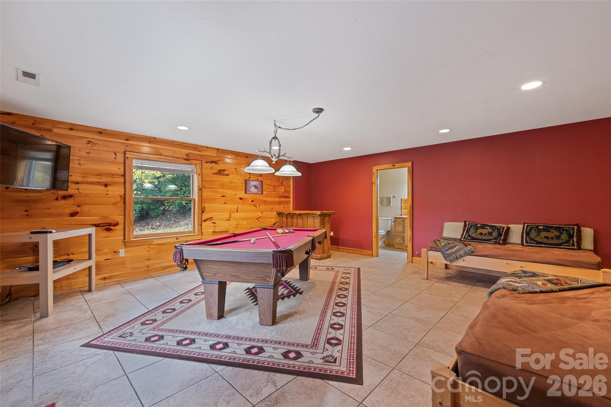 235 Soaring Eagle Road Bryson City, NC 28713 - Photo 28 of 43 a room with furniture a flat screen tv and a floor to ceiling window