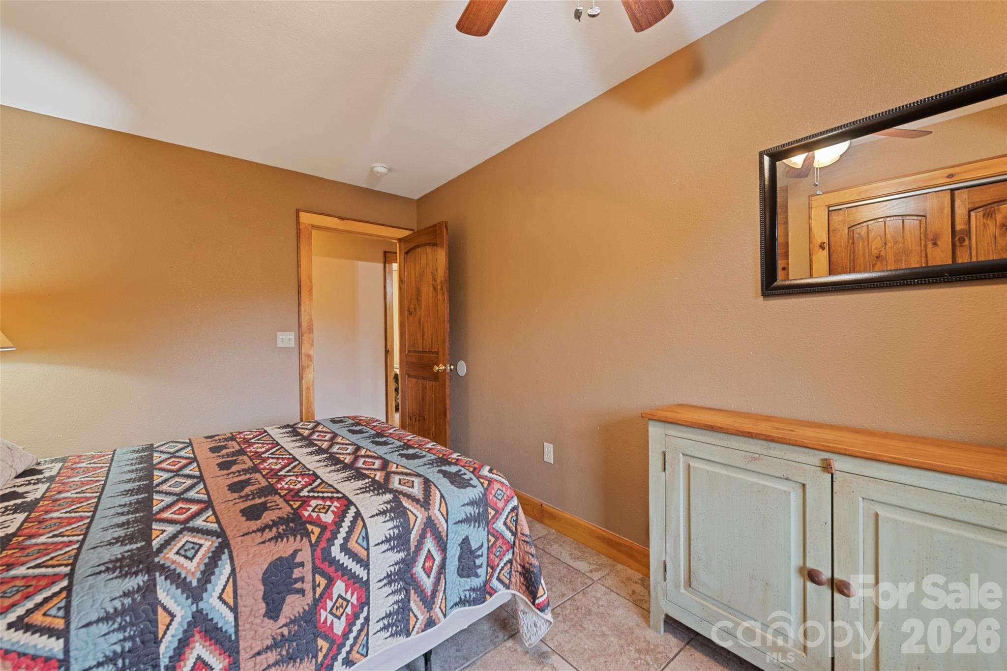 235 Soaring Eagle Road Bryson City, NC 28713 - Photo 32 of 42 a bedroom with a bed and wooden floor