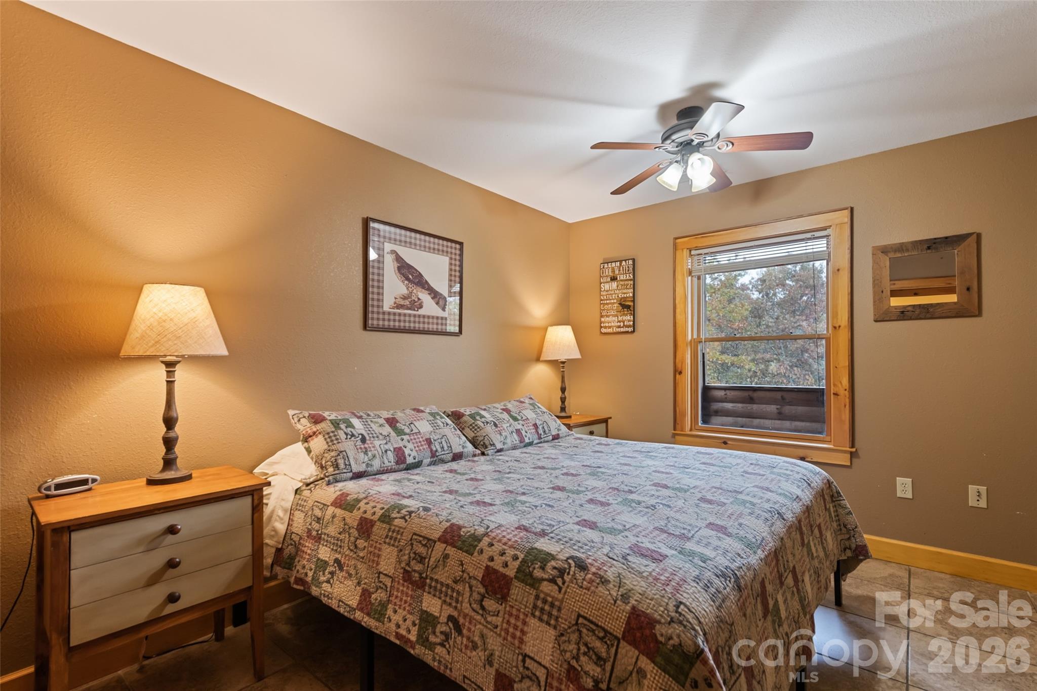 235 Soaring Eagle Road Bryson City, NC 28713 - Photo 33 of 42 a bedroom with a bed and a lamp on dresser