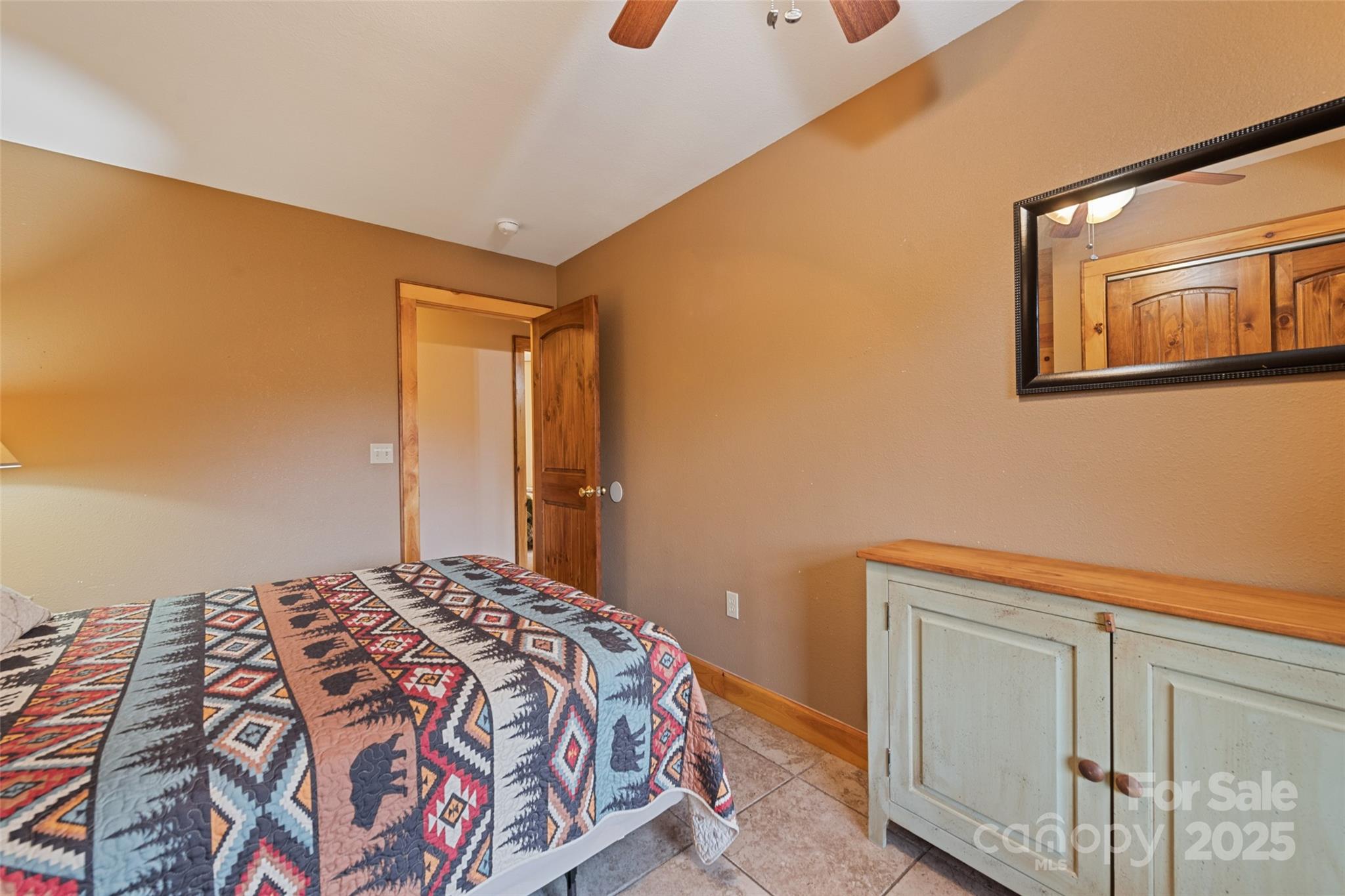 235 Soaring Eagle Road Bryson City, NC 28713 - Photo 34 of 43 a bedroom with a bed and wooden floor