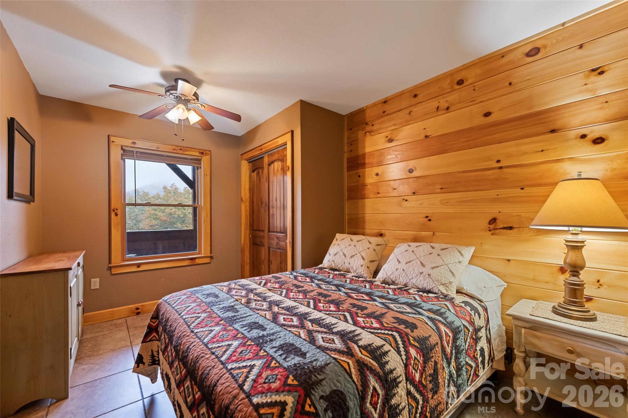 235 Soaring Eagle Road Bryson City, NC 28713 - Photo 34 of 43 a bedroom with a bed and a chandelier